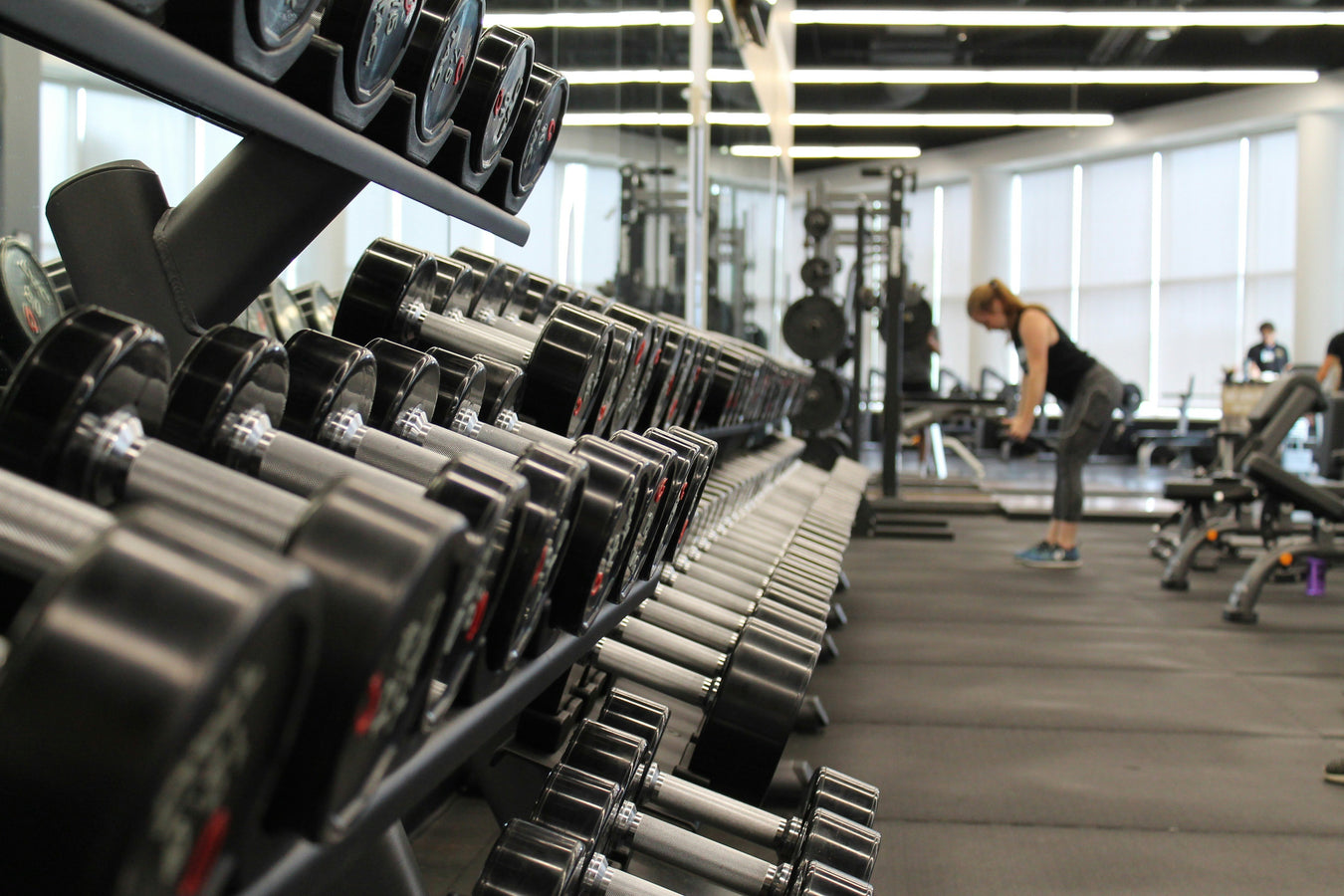 Modern gym setup featuring dumbbells, strength training equipment, and fitness accessories for home and professional workouts.