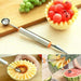 Stainless steel melon baller with carving knife, close-up view