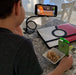 Foldable metal stand for phones, flexible use.
